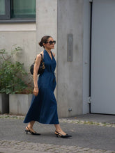 A lady wears a denim midi dress.